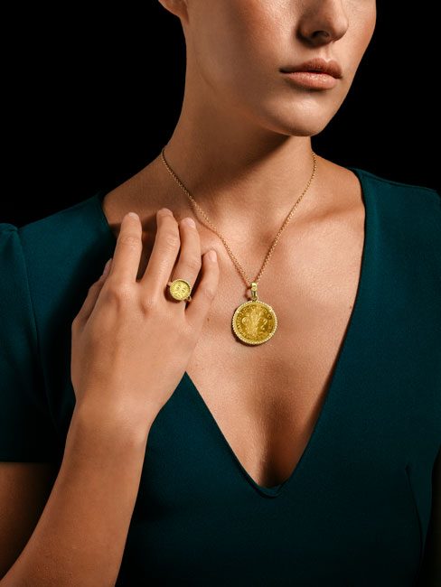 Woman wearing a Gold Florin coin necklace and ring